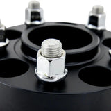 Black wheel spacer with lug nuts from Mishimoto Tesla Wheel Spacer Staggered Bundle 15mm + 20mm