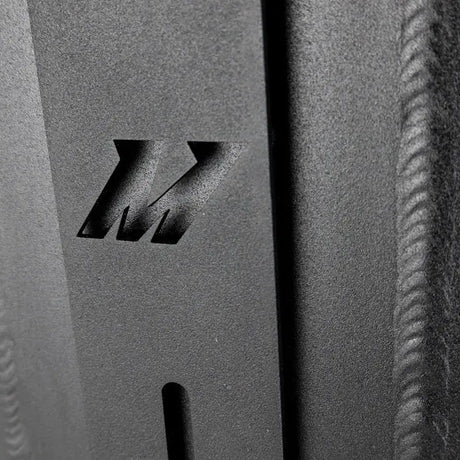 Textured metal with cut-out Mishimoto logo on dual pass intercooler dual side inlet/outlet