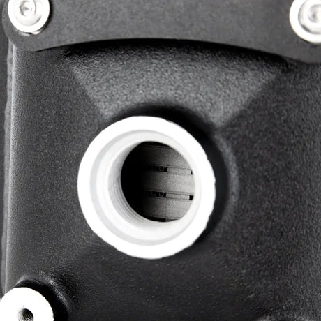 Black metal part with white-rimmed hole on Mishimoto universal air-to-water intercooler