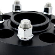 Black Mishimoto wheel spacers with lug nuts for 5x114.3 wheels