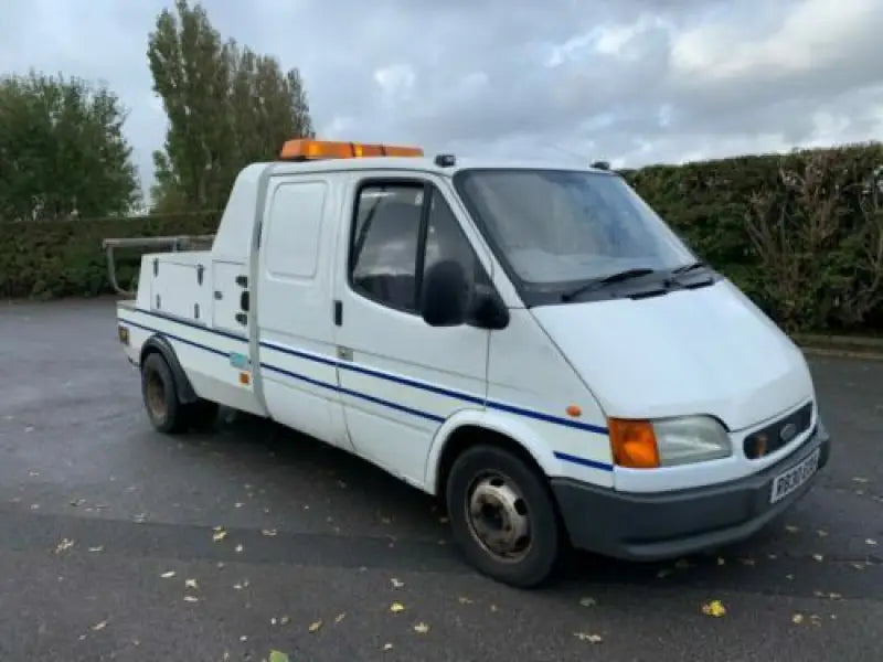 White Ford Transit recovery truck.