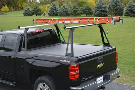 Black pickup truck with ladder rack.