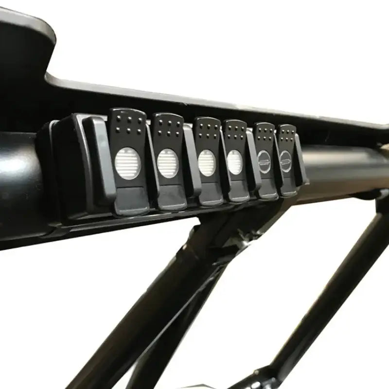 Multi Purpose Light Controller with 6 channels, waterproof connectors, and wireless RF remote mounted on a UTV roll bar. Compatible with 12 to 24 volts, controllable via Android/IOS app. For efficient electronic accessory management and quick installation.