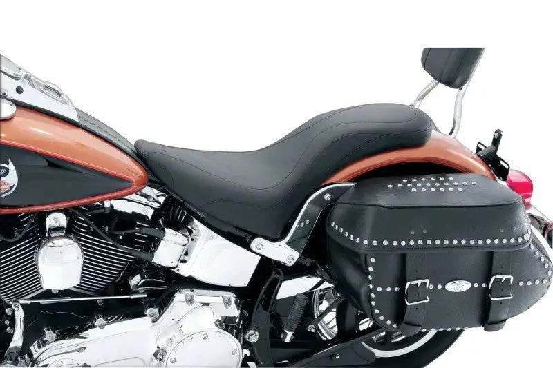 Motorcycle with studded saddlebag and Mustang 84-99 Harley Standard Rear Tire DayTripper 1PC seat in black