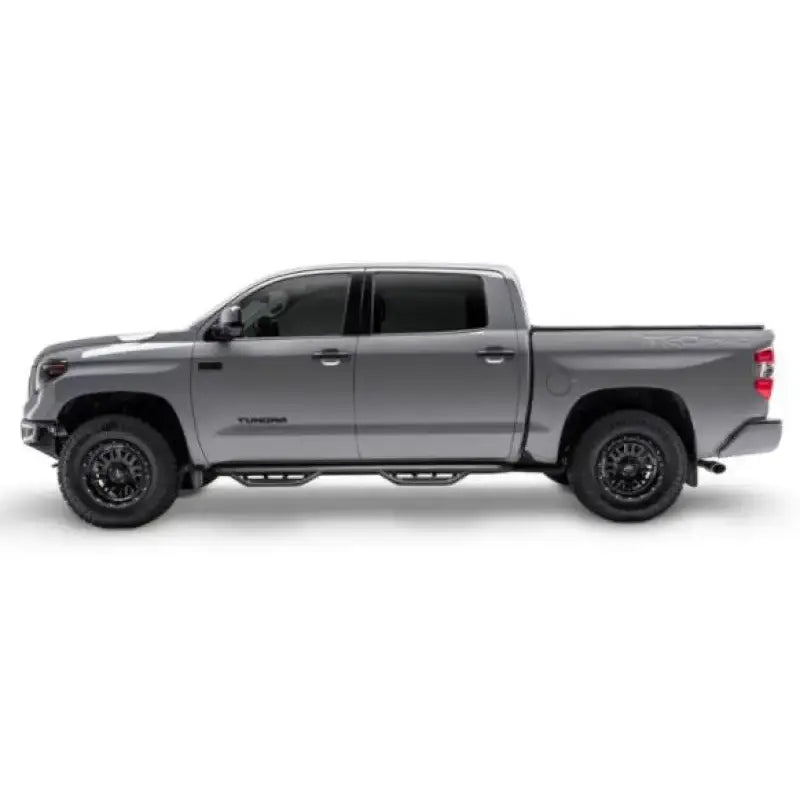 Gray Toyota Tundra with matte black stainless steel nerf bar and drop down steps