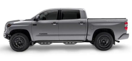 Gray Toyota Tundra with matte black stainless steel nerf bar and drop down steps