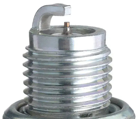 Shiny metal CR6HIX Iridium IX spark plug in a spark plug box for optimal performance