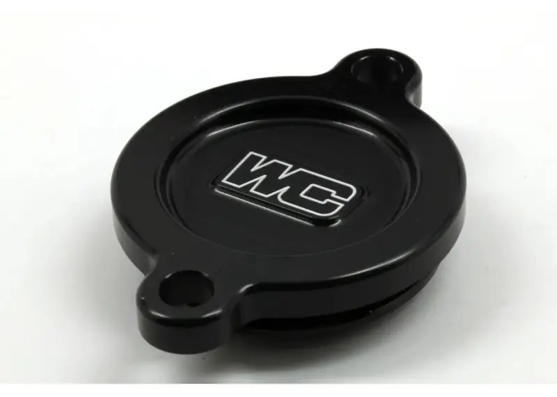 Black circular oil filter cover with mounting holes for Kaw engines