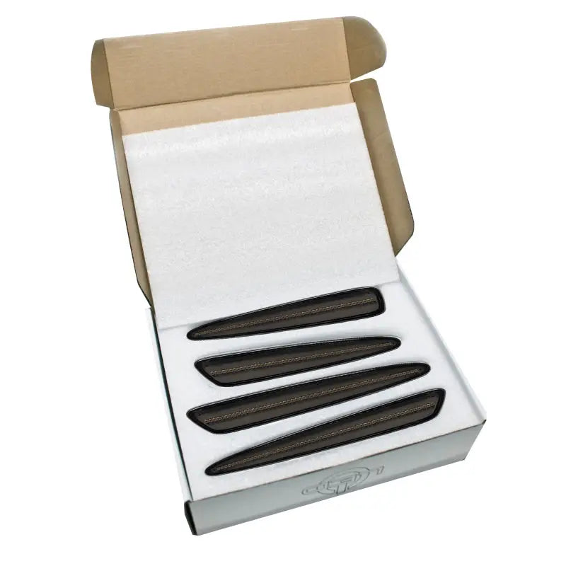 Open cardboard box with four dark elongated objects for Chevrolet Corvette concept sidemarker set