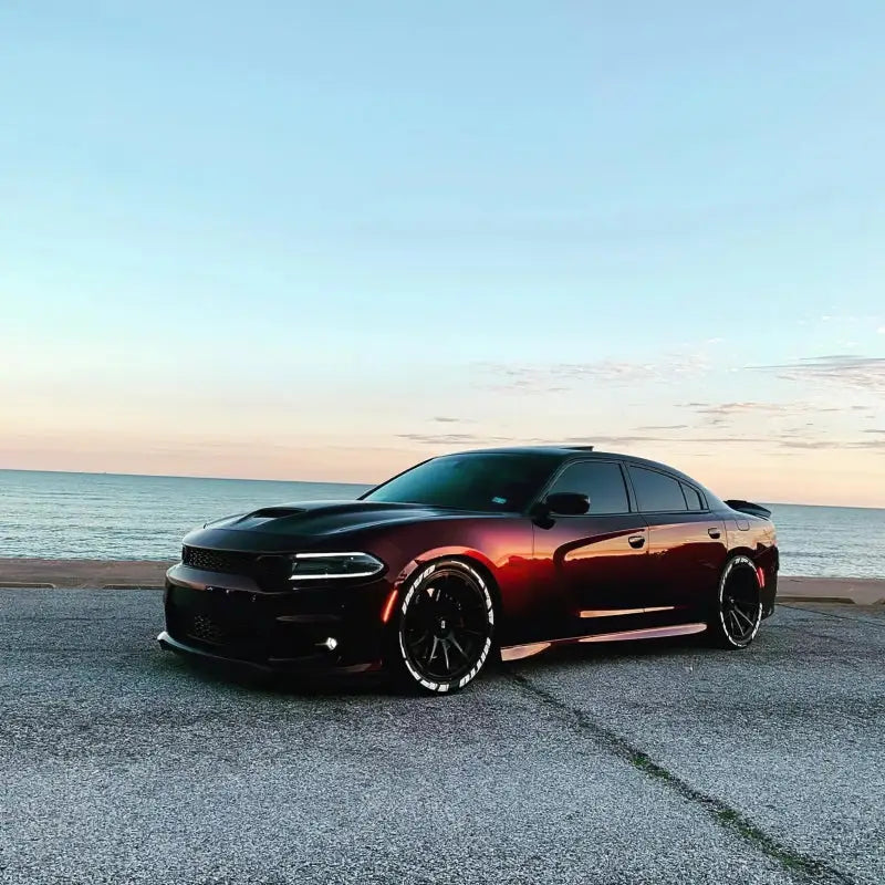 Deep red Dodge Charger with black hood and aftermarket wheels showcasing Oracle sidemarker set