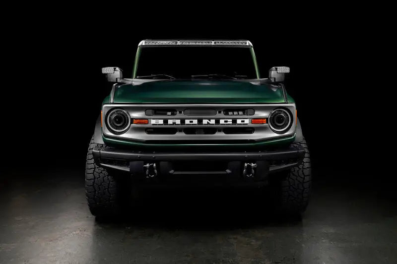 Green Ford Bronco with off-road tires showcasing Oracle Bi-LED projector headlights