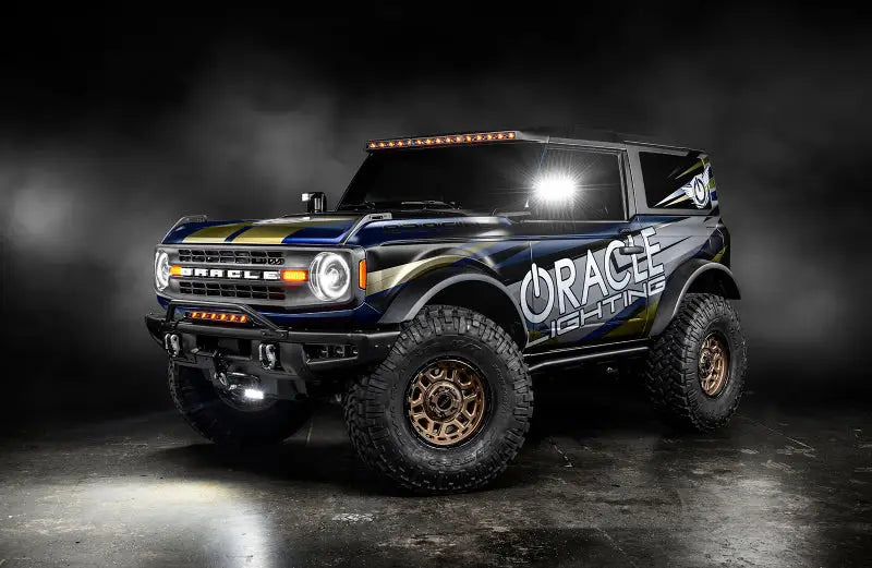Blue and gold Bronco with custom Oracle Bi-LED Projector Headlights shining bright