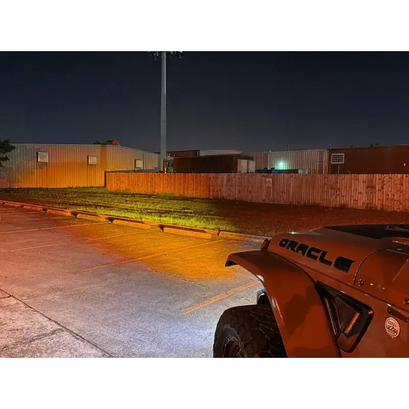 a jeep parked in a parking lot at night