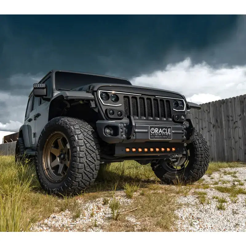 a black jeep parked in a grassy field