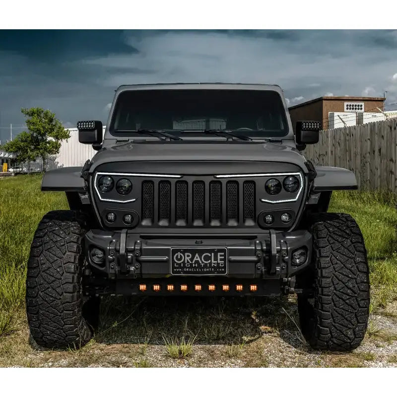 a black jeep is parked in the grass
