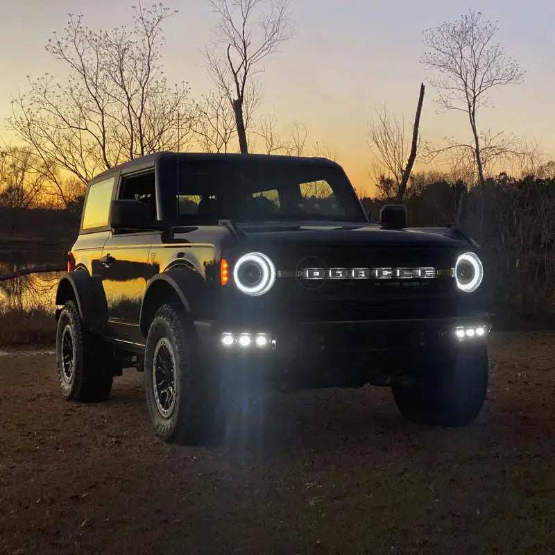 Black Ford Bronco with illuminated headlights in ORACLE Lighting fog light kit for 21-22 Bronco