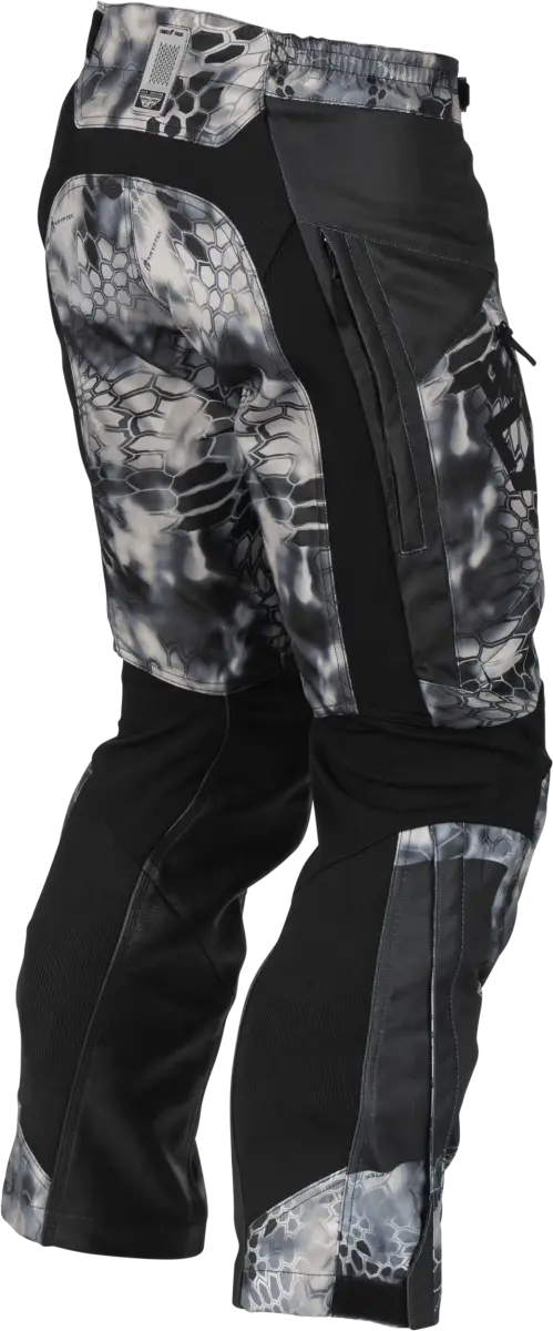 Camouflage and black snow pants easily allow access to the lower leg for outdoor adventures