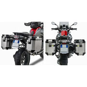 Motorcycle with PL5108CAM Side Case Hardware Outback installed, featuring V35 MONOKEY® SIDE series cases in matte black with red lenses for improved aerodynamics and increased storage capacity.