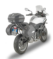 White and grey touring motorcycle with saddlebags and top case showing PLO5137MK luggage mounting hardware