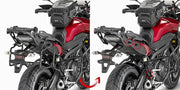 Red motorcycle with matte black hard luggage mounting hardware and tank bag