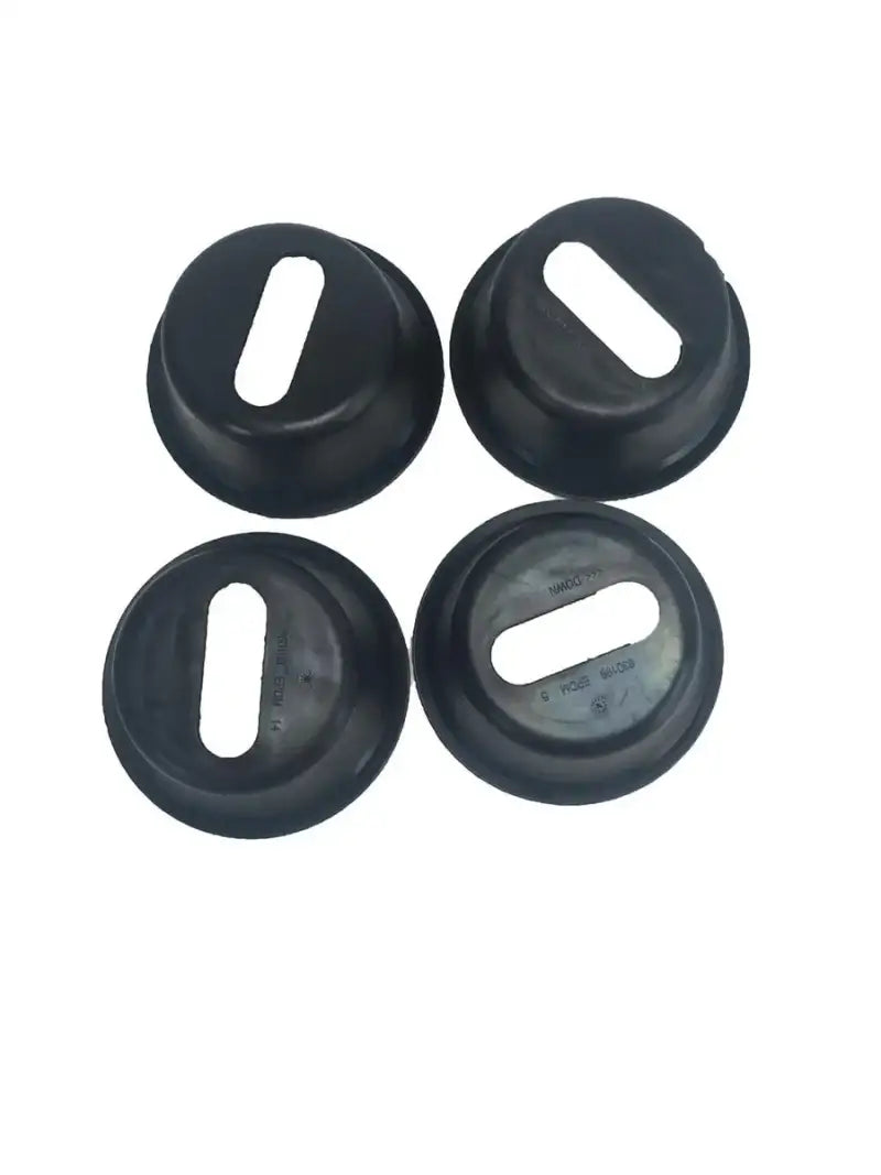 Four black rubber grommets with rectangular holes for cleat hole boot pockets