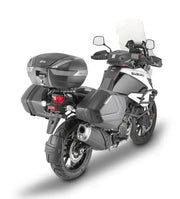 White and black Suzuki adventure motorcycle with Givi luggage mounting hardware in matte black