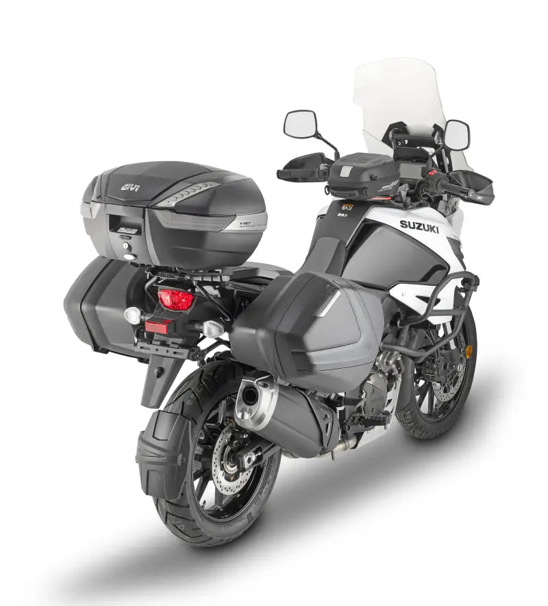 White and black Suzuki adventure motorcycle with Givi luggage mounting hardware in matte black