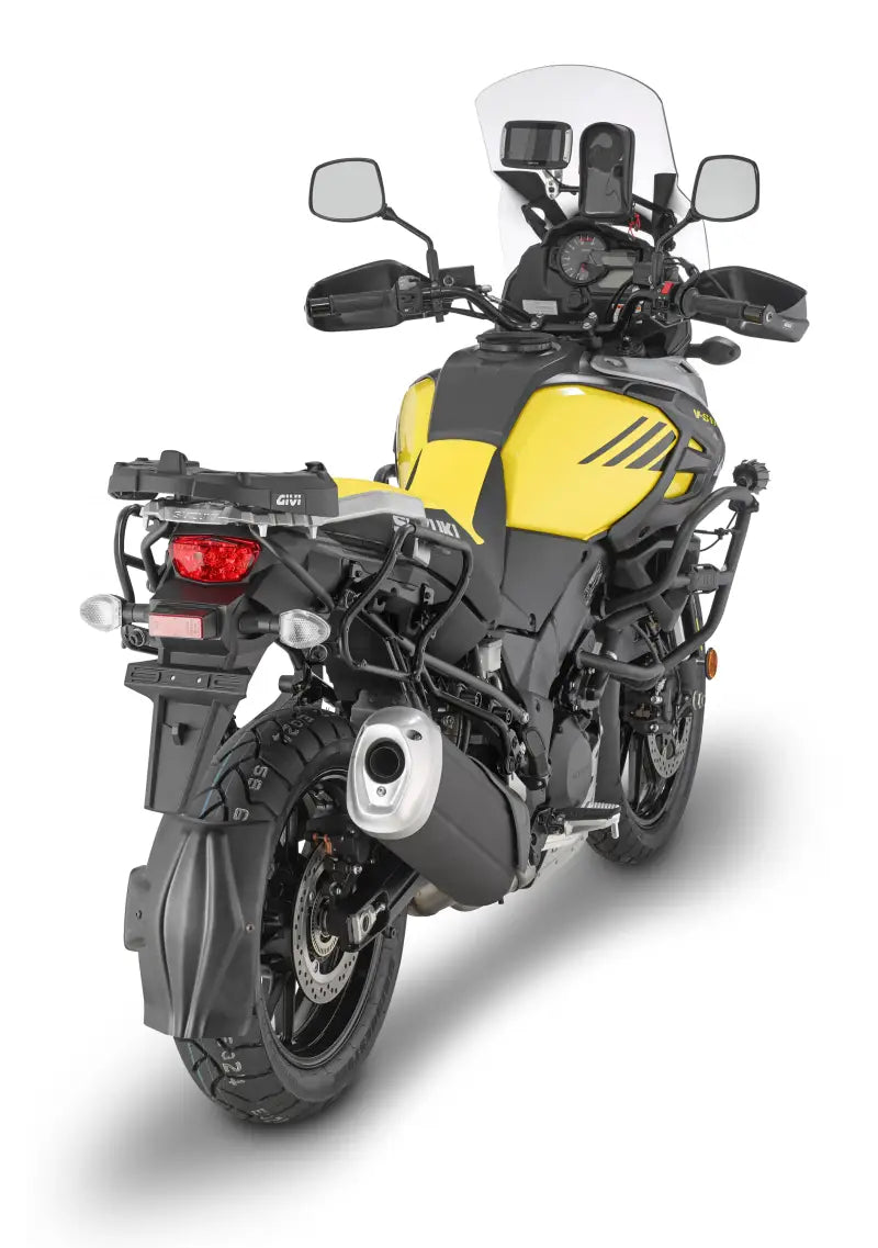 Yellow adventure motorcycle with matte black hard luggage mounting hardware and luggage racks