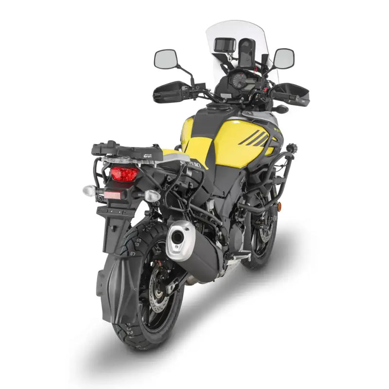 Yellow adventure motorcycle with matte black hard luggage mounting hardware and luggage racks