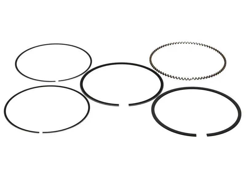 ProX ring set with four black piston rings, one serrated edge