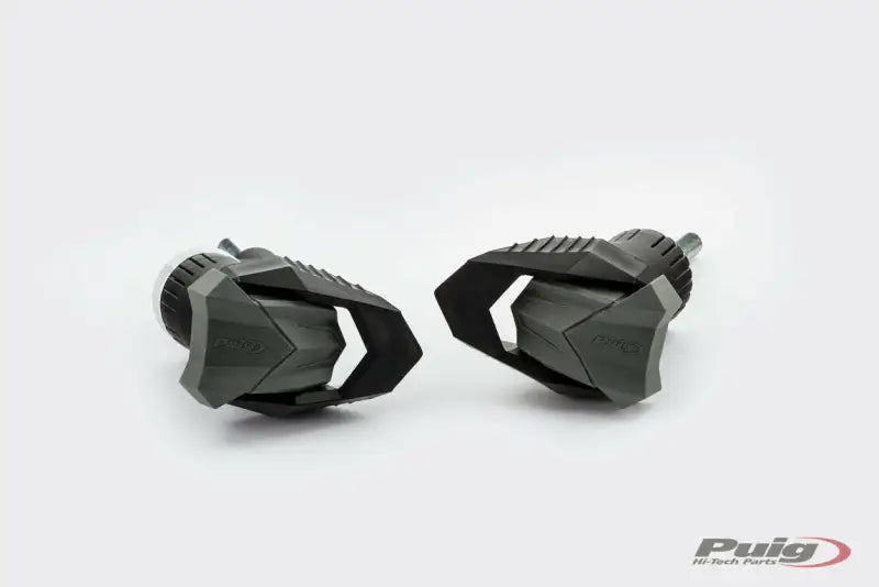 Dark gray Puig 9753N frame sliders with textured surfaces for R19 motorcycle