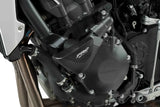 Black motorcycle engine with Puig 9754N frame sliders and visible hoses