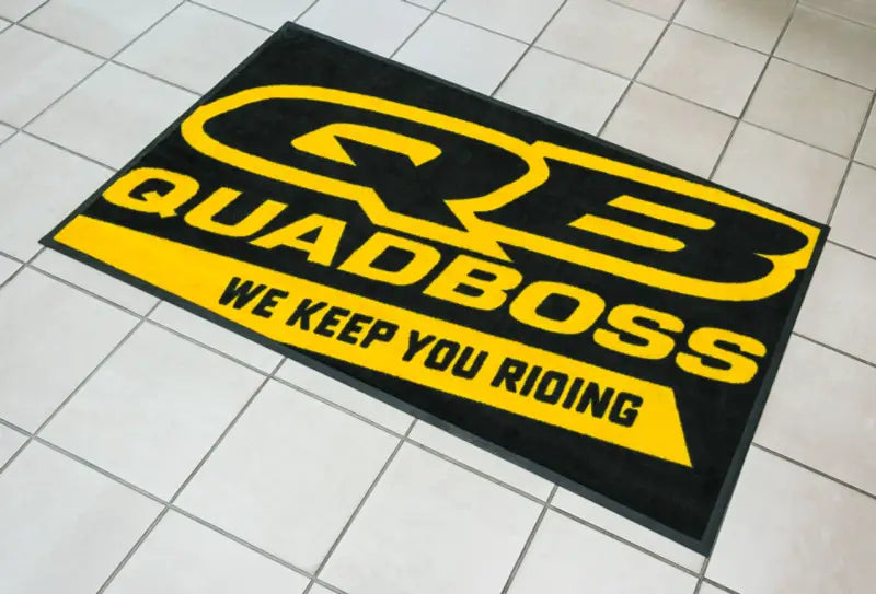 Quadboss 3x6 floor shop mat with bold yellow black design