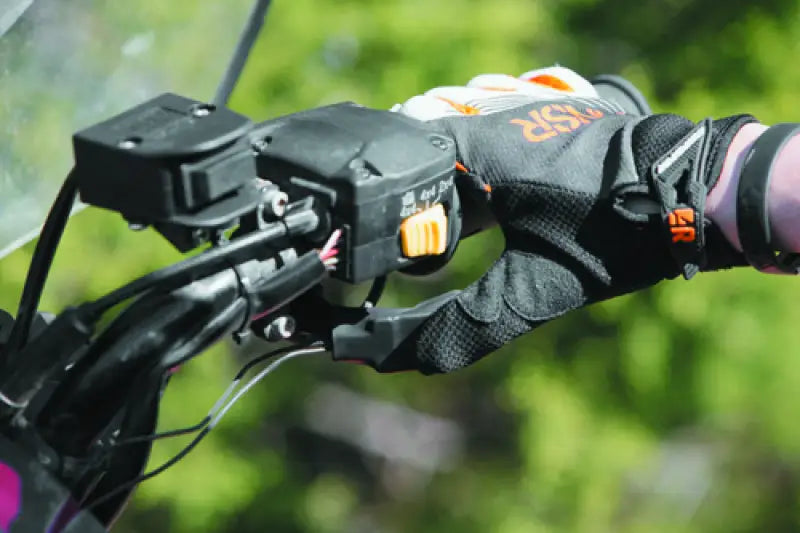 Motorcycle handlebar with gloved hand using QuadBoss Heated Grips with thumb warmer