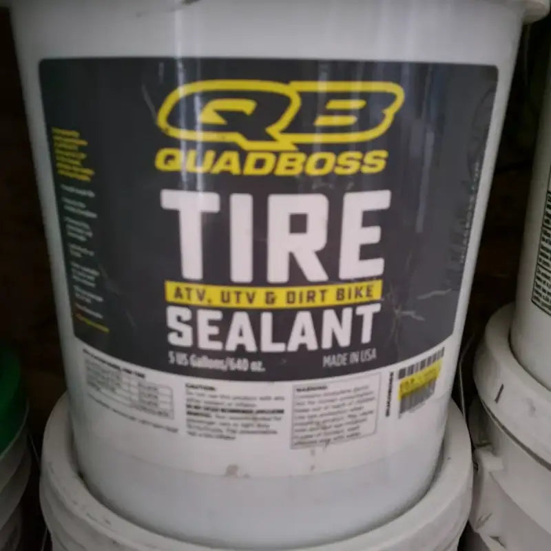 "QuadBoss Tire Sealant 5gal - 530855 container designed for ATV, UTV, and dirt bike use, ensuring leak prevention and durable protection."