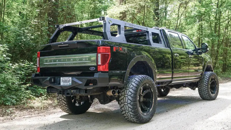 RACK01-01-1 Fab Fours Adjustable Rack System mounted on a black Ford truck, showcasing its durable construction and versatile design for transporting cargo.