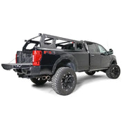 Fab Fours Adjustable Rack System (RACK01-01-1) mounted on a black FX4 truck, showcasing its sleek black and gray finish and ample cargo space.