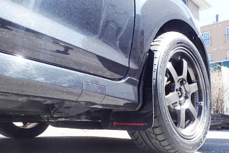 Black mud flap with Rally Armor logo on Ford Fiesta ST with aftermarket rally mud flaps