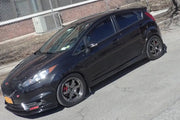 Black mud flap with Rally Armor logo on Ford Fiesta ST with aftermarket wheels and red calipers