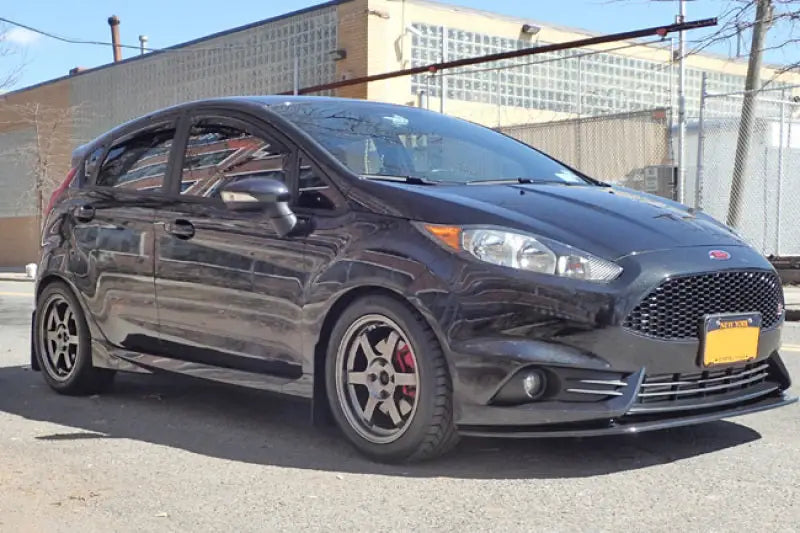 Black mud flap with Rally Armor logo on Ford Fiesta ST hatchback with custom wheels