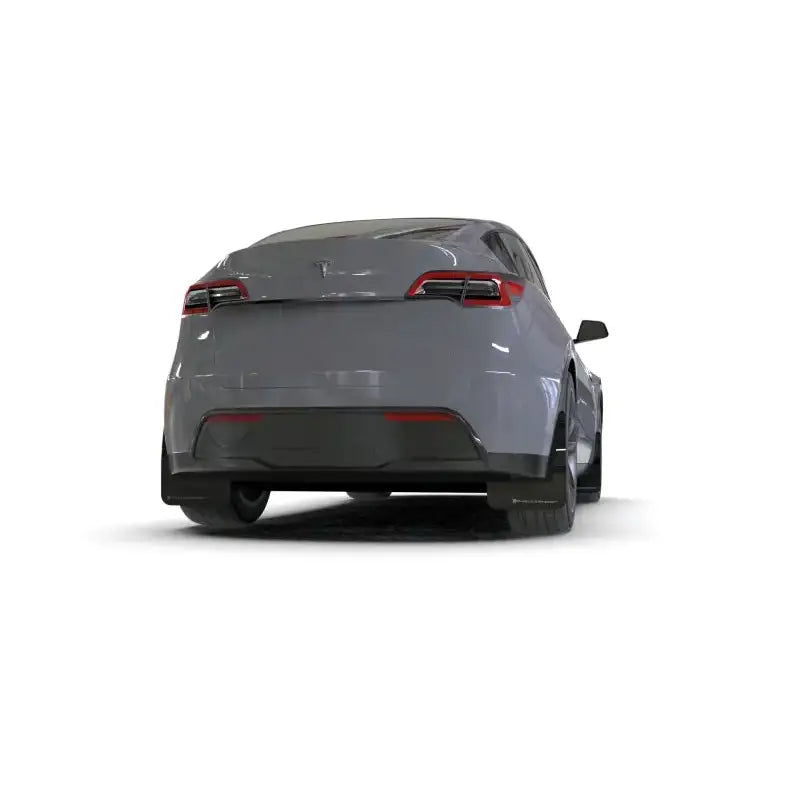 Gray electric crossover SUV with Rally Armor mud flaps for a Tesla Model Y