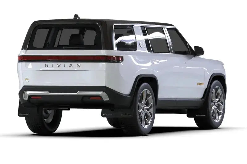 White Rivian R1S electric SUV with black roof, silver wheels, and white logo mud flap