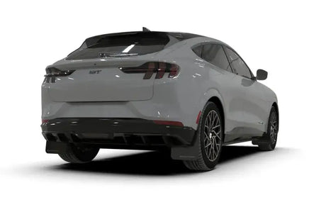 Rear view of light gray Ford Mustang Mach-E with black wheels and metallic black logo mud flaps