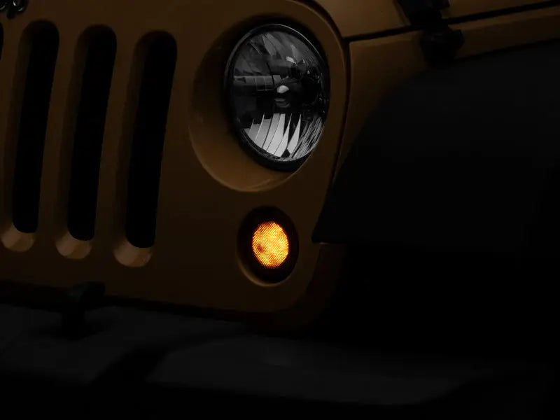 Yellow Jeep Wrangler front end with Raxiom Axial Series LED turn signals