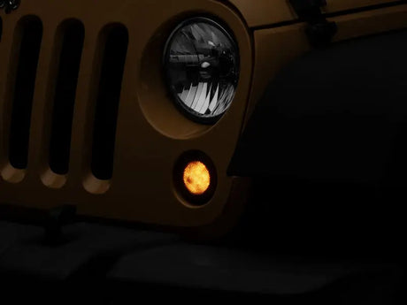 Yellow Jeep Wrangler front end with Raxiom Axial Series LED turn signals