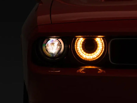Red car’s illuminated headlights featuring dodge challenger halo and sequential turn signals