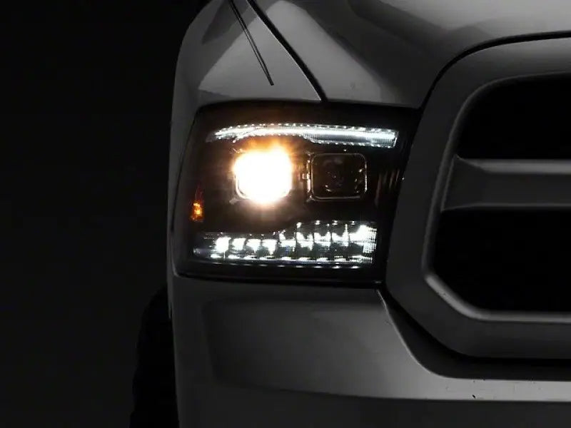 Illuminated truck headlight showing Raxiom LED projector headlights with switchback signals