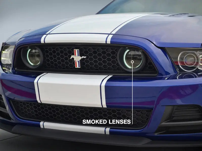 Blue Mustang with white racing stripes featuring Raxiom CCFL Halo Fog Lights for bold style