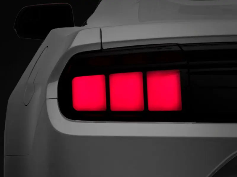 Rear view of white Ford Mustang with smoked lens profile LED tail lights and red taillights
