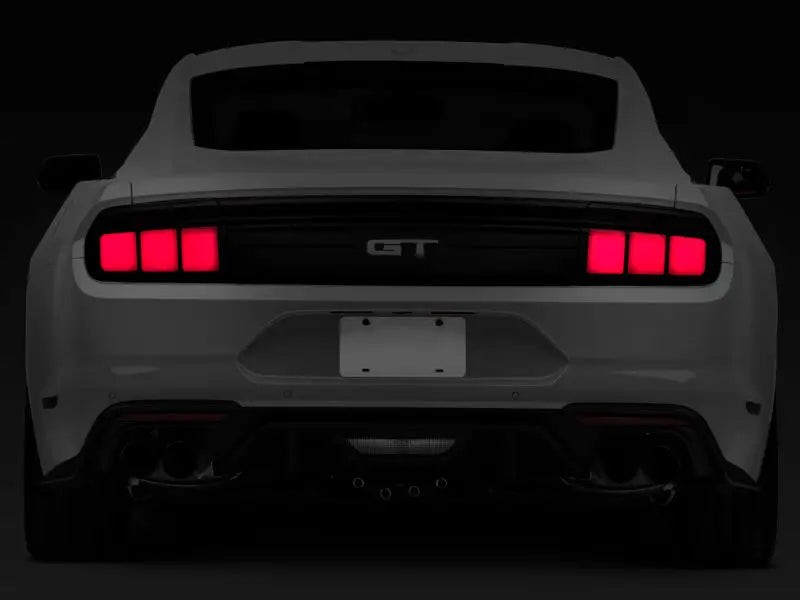 Rear view of white Ford Mustang with smoked lens profile LED tail lights and red taillights
